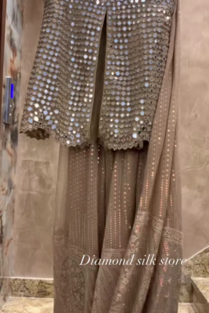 Champagne Mirror‑Work Sleeveless Long Top with Front Slit and Coordinated Flowing Skirt Contemporary Festive Set” ✨